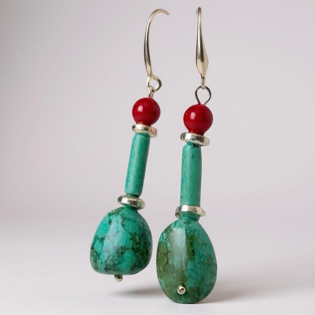 Handmade turquoise and coral gemstone drop earrings with silver ear wire closure. Features natural turquoise teardrop stones paired with round coral   and silver-plated accents. Lightweight boho style dangle earrings, perfect for everyday wear, gifts, or special occasions