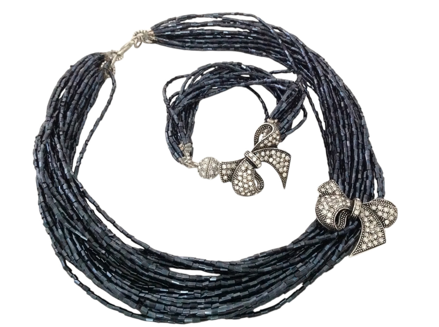 Semra Ascioglu multi-strand midnight-blue beaded necklace and bracelet set with crystal-encrusted bow charms.