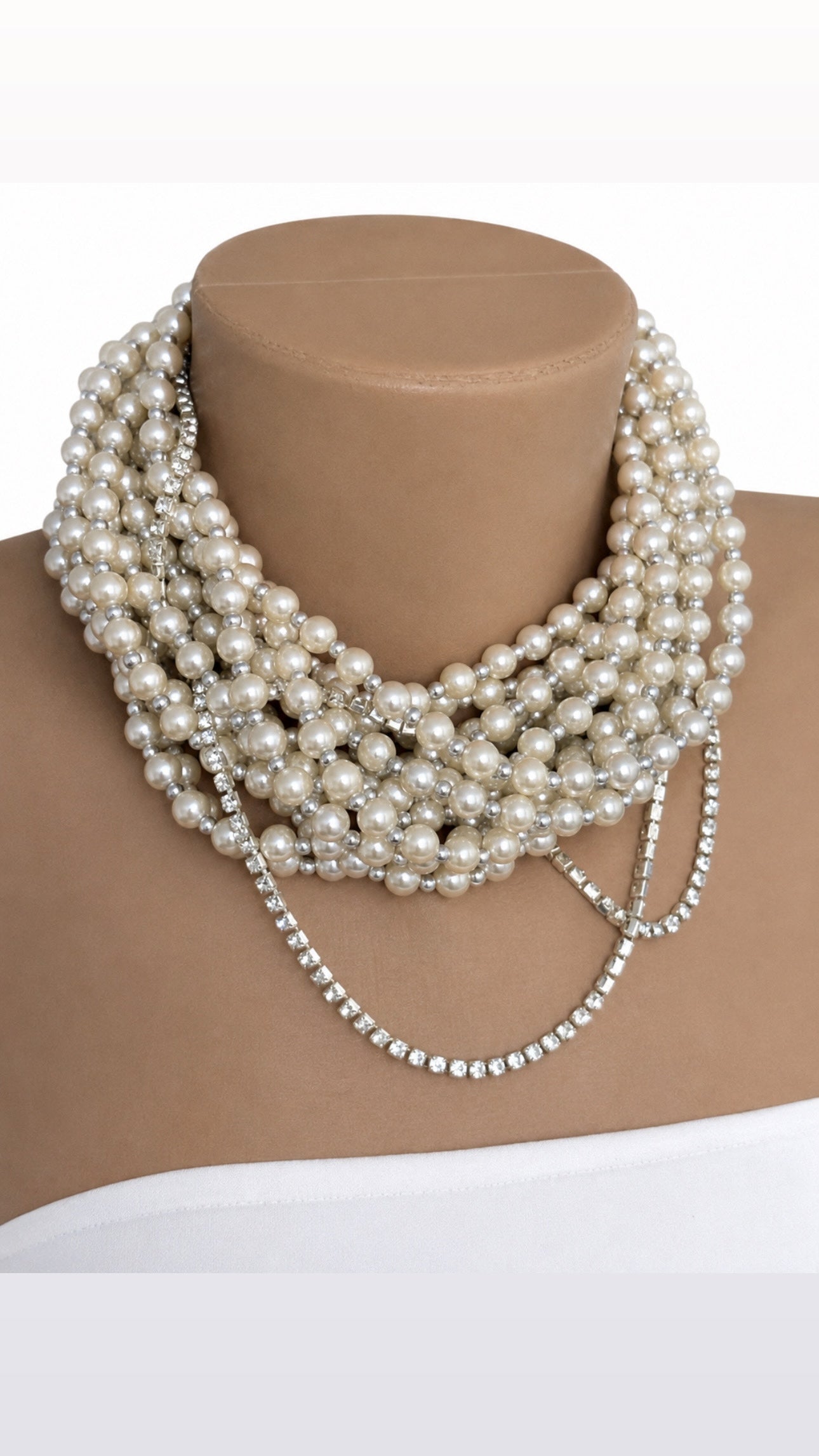 Semra Ascioglu multi-strand white pearl statement necklace with sparkling crystal chain accents on a mannequin bust.