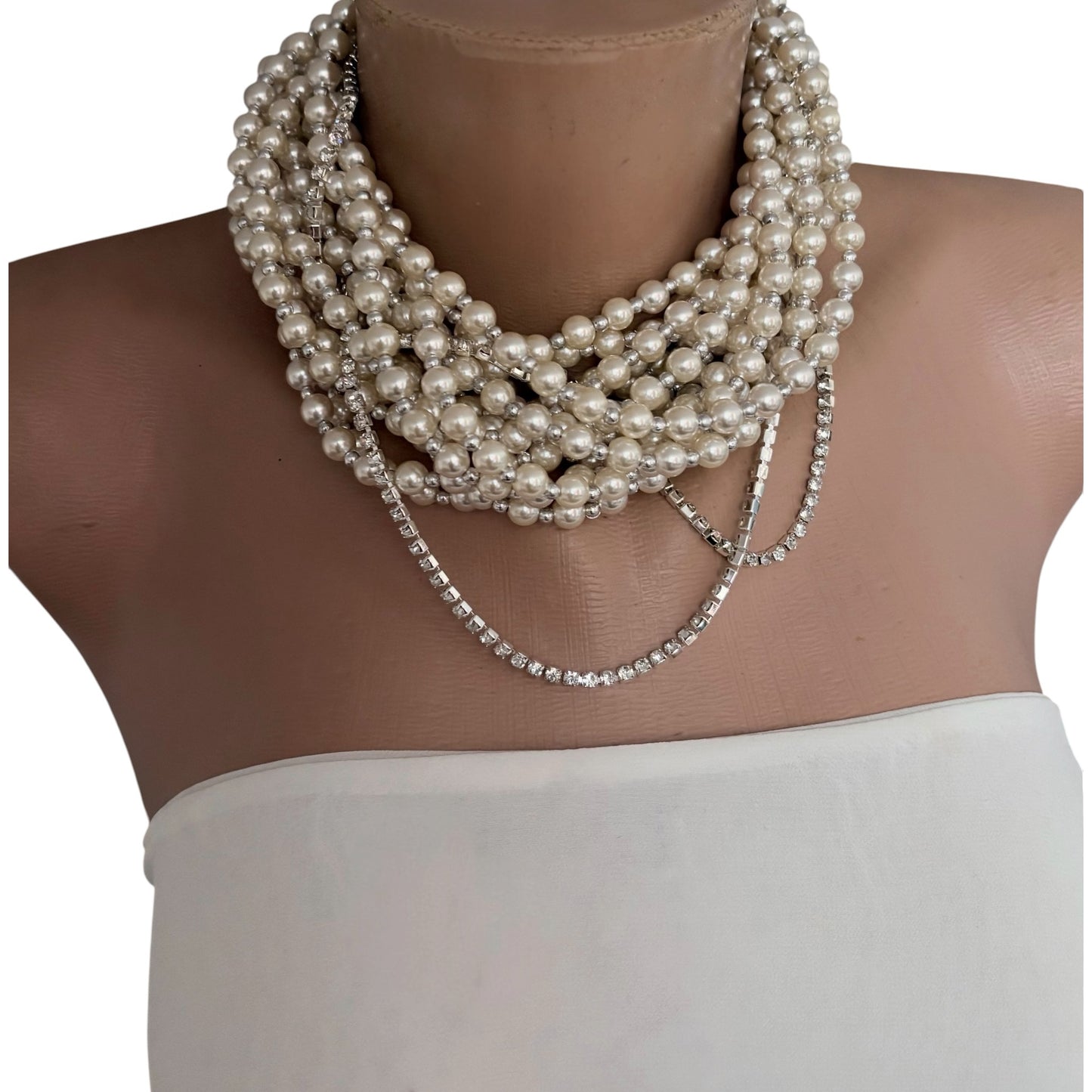Semra Ascioglu multi-strand white pearl statement necklace with sparkling crystal chain accents on a mannequin bust.